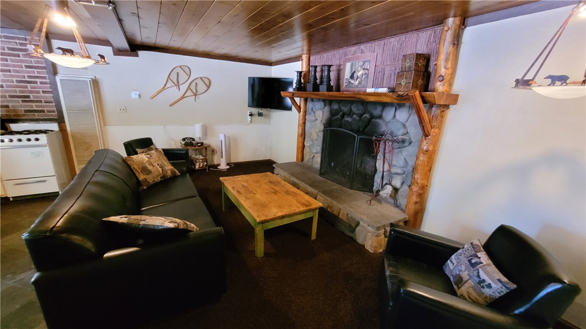42268 Moonridge Road Big Bear Lake, CA 92315 - Photo 49 of 54 a living room with furniture and a fireplace