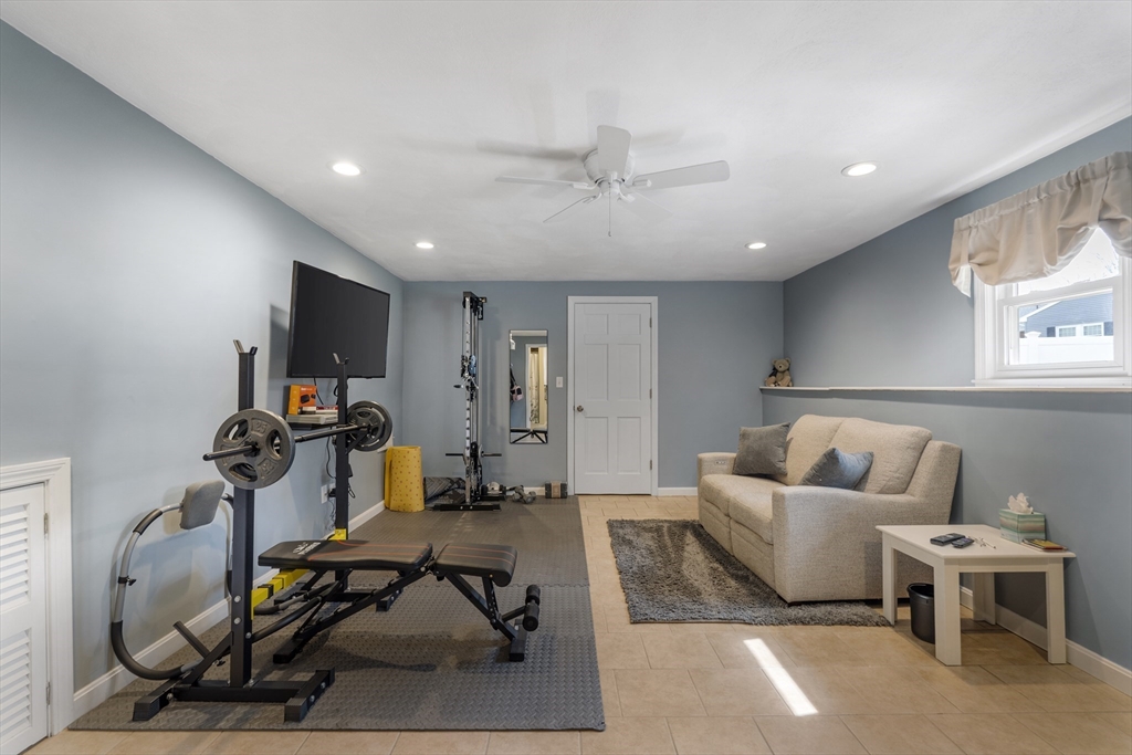 27 Leo's Lane Avon, MA 02322 - Photo 11 of 30 a living room with furniture a flat screen tv and a window