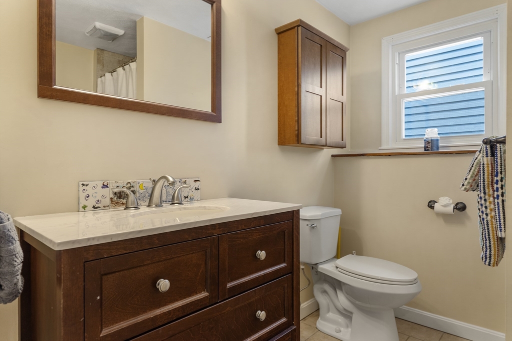 27 Leo's Lane Avon, MA 02322 - Photo 12 of 30 a bathroom with a toilet sink and mirror