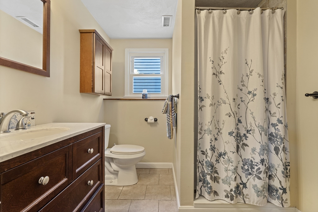 27 Leo's Lane Avon, MA 02322 - Photo 13 of 30 a bathroom with a granite countertop sink toilet and shower
