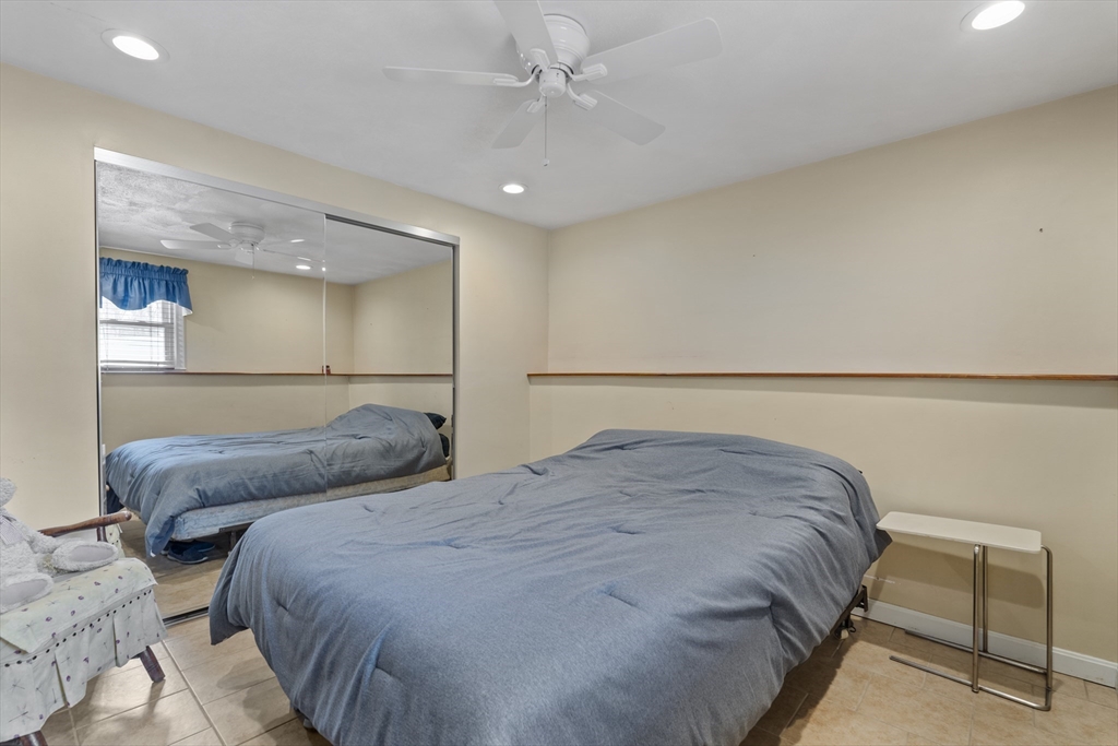 27 Leo's Lane Avon, MA 02322 - Photo 14 of 30 a bedroom with a bed and a chair