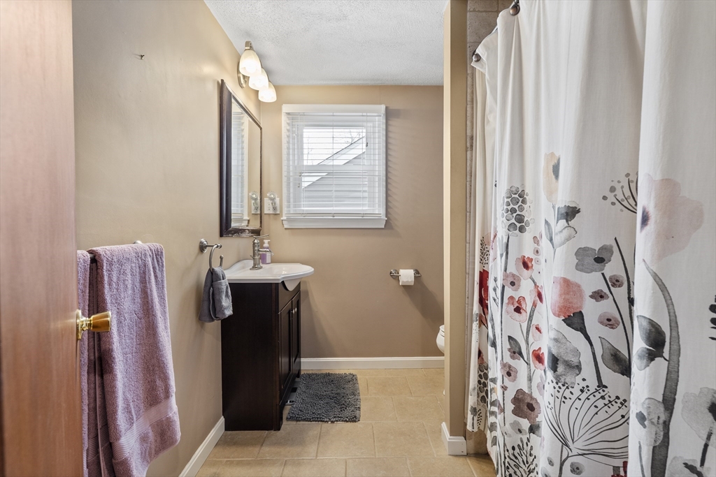 27 Leo's Lane Avon, MA 02322 - Photo 18 of 30 a bathroom with a sink and a mirror