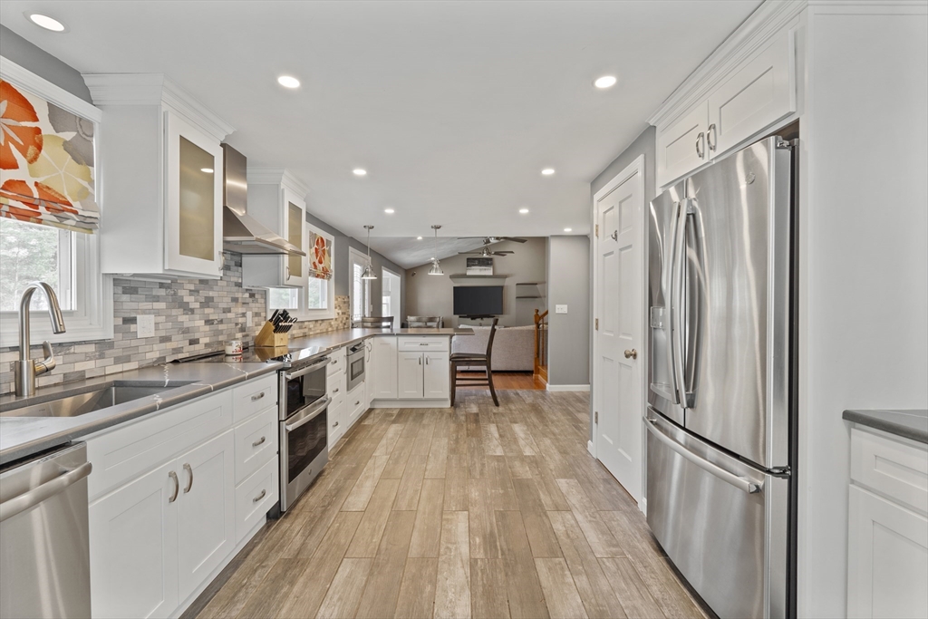 27 Leo's Lane Avon, MA 02322 - Photo 2 of 30 a kitchen with stainless steel appliances a refrigerator sink and white cabinets
