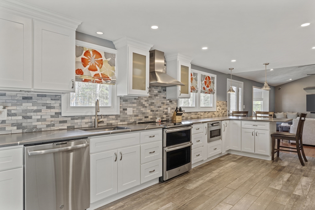 27 Leo's Lane Avon, MA 02322 - Photo 3 of 30 a kitchen with stainless steel appliances granite countertop a sink and cabinets