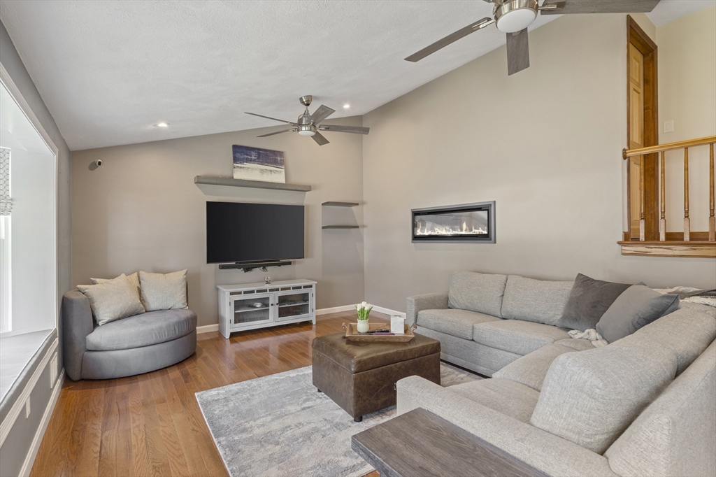 27 Leo's Lane Avon, MA 02322 - Photo 8 of 30 a living room with furniture and a flat screen tv