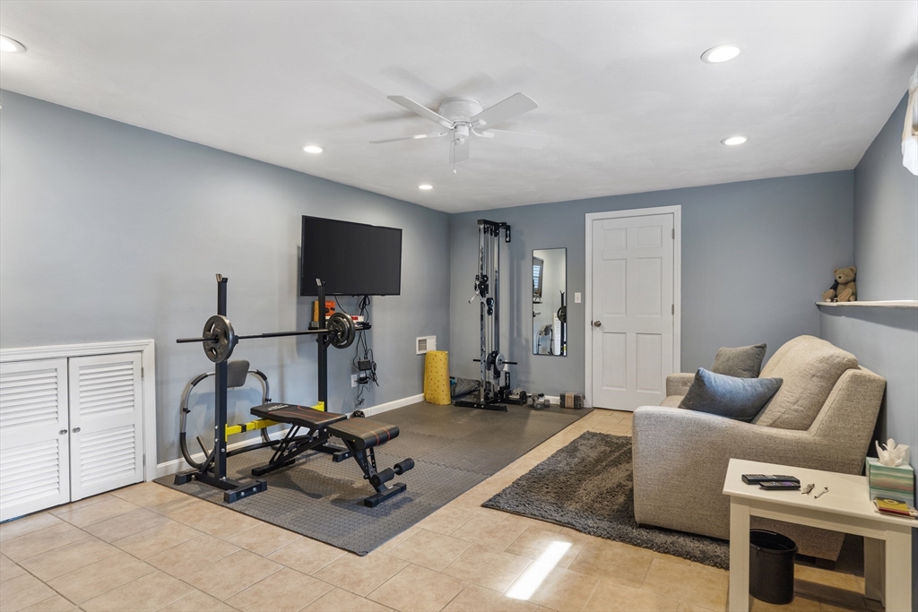 27 Leo's Lane Avon, MA 02322 - Photo 10 of 30 a room with furniture a flat screen tv and a ceiling fan