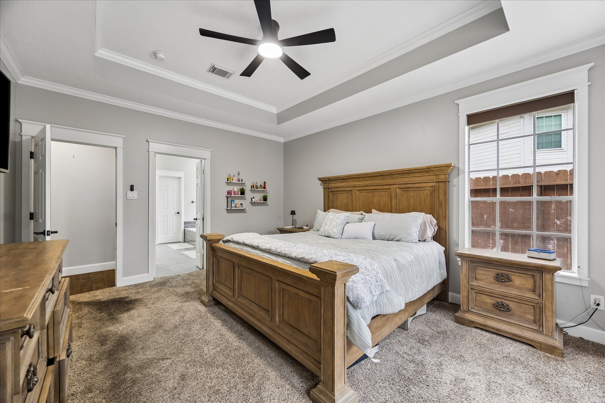 23039 Enchanted Landing Lane Katy, TX 77494 - Photo 17 of 30 a spacious bedroom with a bed a dresser and a chandelier