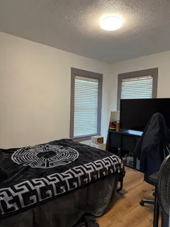 a bedroom with a bed and a window