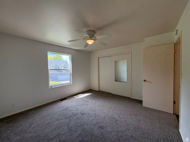 595 Meadowlark Road Orem, UT 84097 - Photo 36 of 87 Carpeted room featuring a ceiling fan with integrated lighting, a double-pane window, and a sliding closet door with a mirrored panel