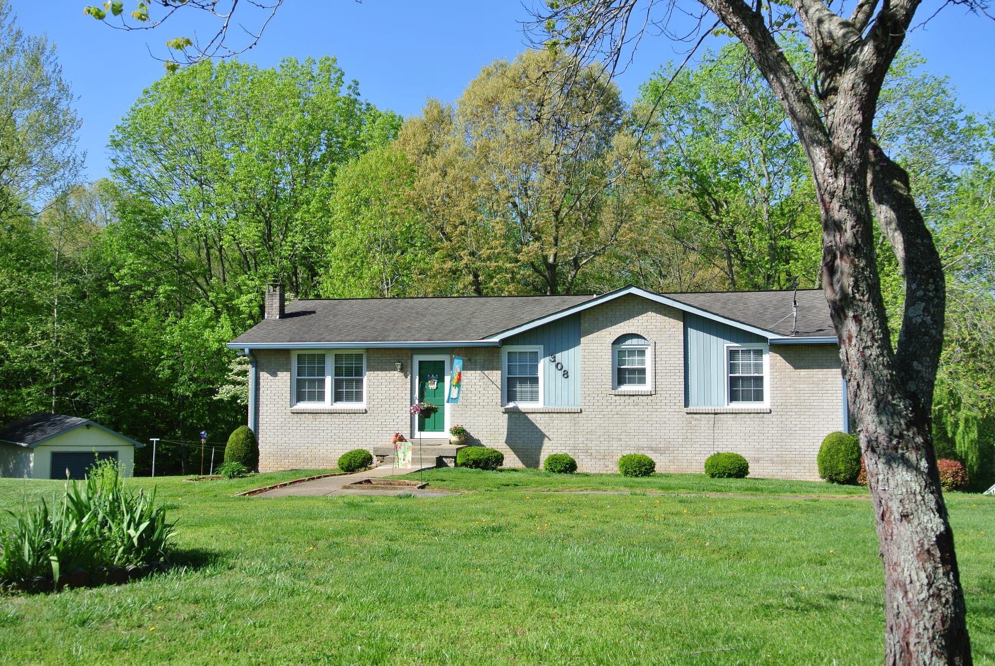 308 Dean Road Clarksville, TN 37040 - Photo 1 of 18 a front view of a house with a garden