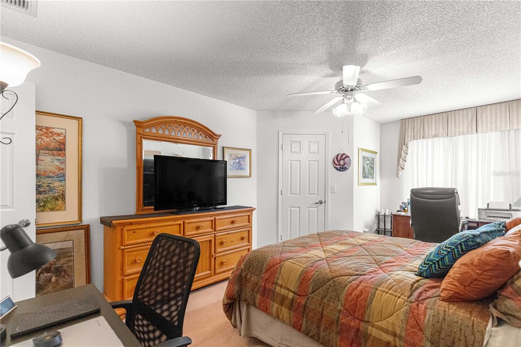 8145 Southwest 109th Street Ocala, FL 34481 - Photo 19 of 43 a bedroom with a bed and a flat screen tv