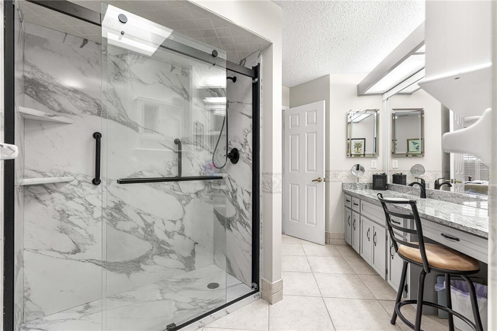 8145 Southwest 109th Street Ocala, FL 34481 - Photo 22 of 43 a bathroom with a granite countertop shower a sink and a mirror