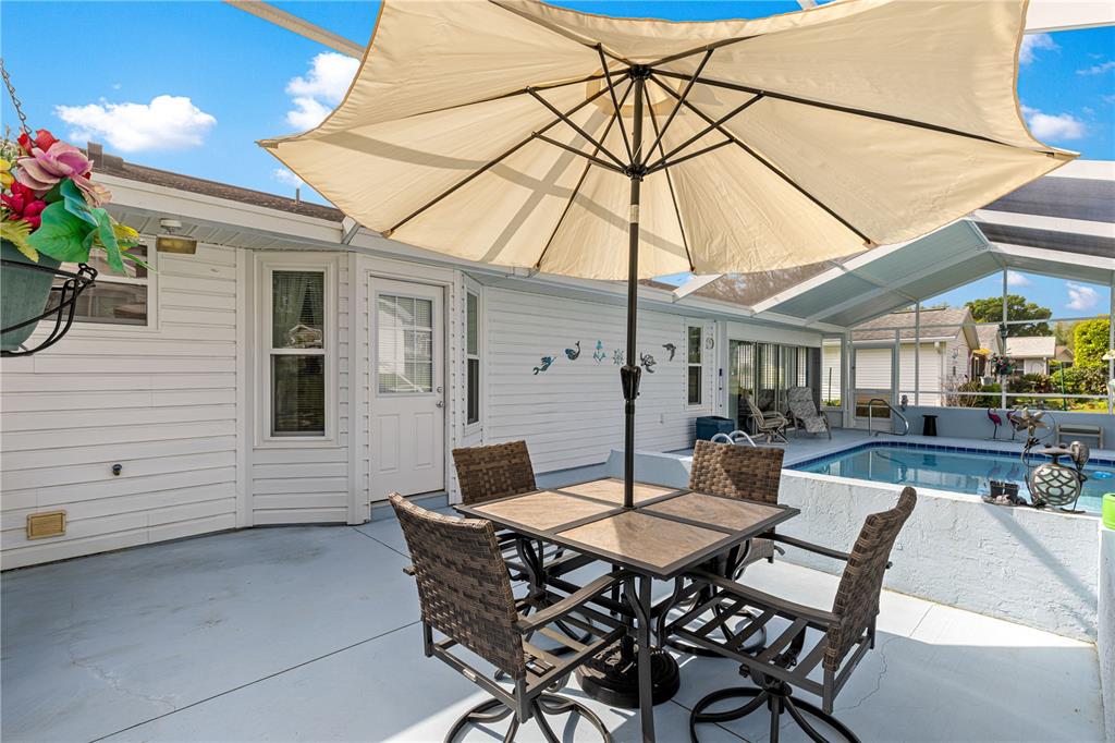 8145 Southwest 109th Street Ocala, FL 34481 - Photo 32 of 43 a backyard of a house with table and chairs