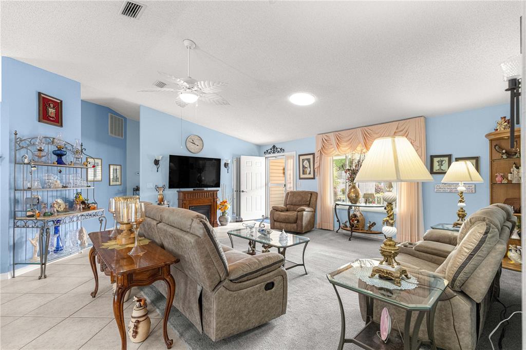 8145 Southwest 109th Street Ocala, FL 34481 - Photo 5 of 43 a living room with furniture and a flat screen tv