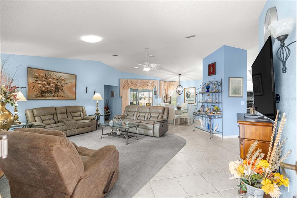 8145 Southwest 109th Street Ocala, FL 34481 - Photo 6 of 43 a living room with furniture and a flat screen tv