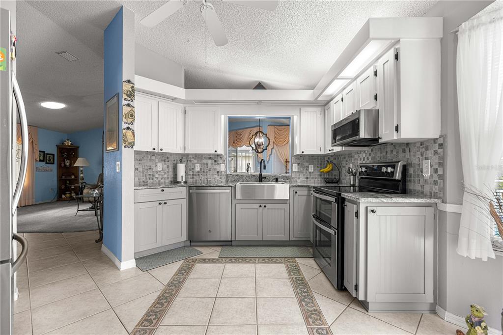 8145 Southwest 109th Street Ocala, FL 34481 - Photo 9 of 43 a kitchen with a sink cabinets and window
