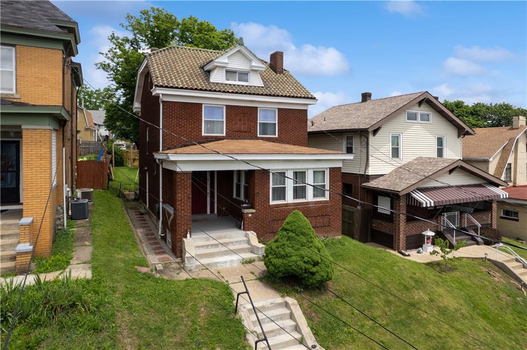 53 Calhoun Avenue Pittsburgh, PA 15210 - Photo 22 of 30 a front view of a house with a yard table and chairs