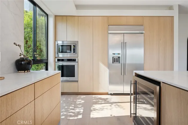 a kitchen with stainless steel appliances granite countertop a refrigerator and a sink
