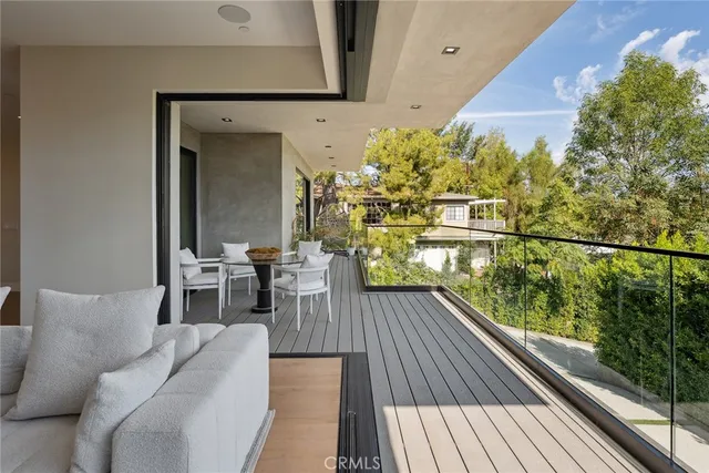 a balcony with table and chairs