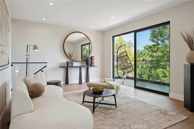 a living room with furniture a projector and a large window