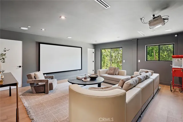 a bathroom with a sink a toilet a mirror and shower