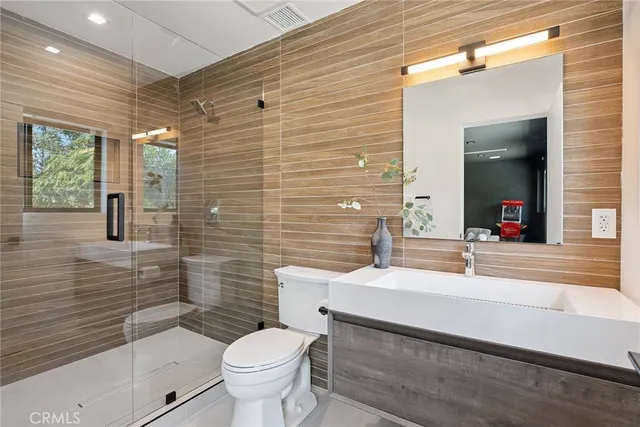 a view of an empty room with stairs and wooden floor