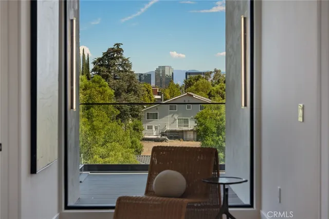 a bedroom with a large bed and a large window
