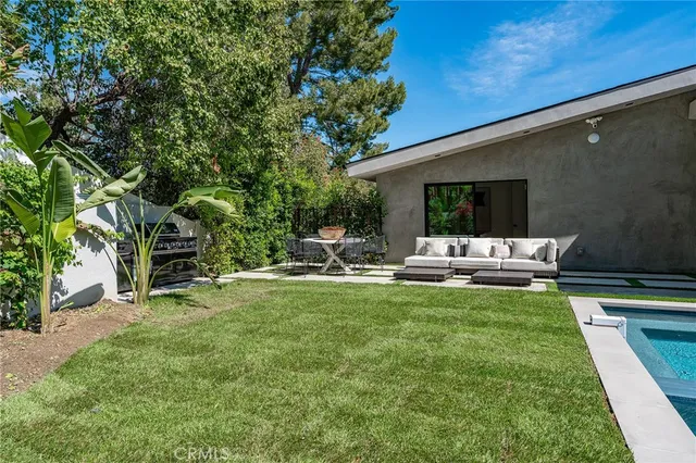 a view of a backyard with a swimming pool