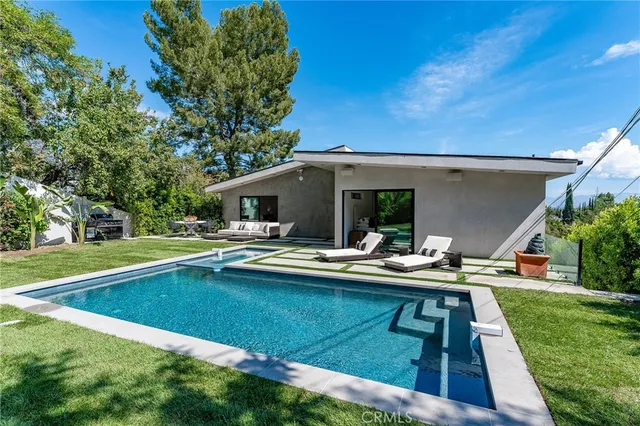 a view of swimming pool with outdoor seating and yard