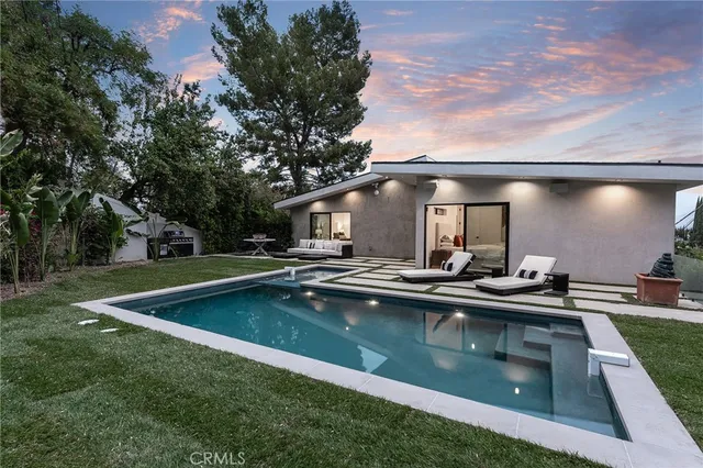 a front view of a house with a yard and balcony