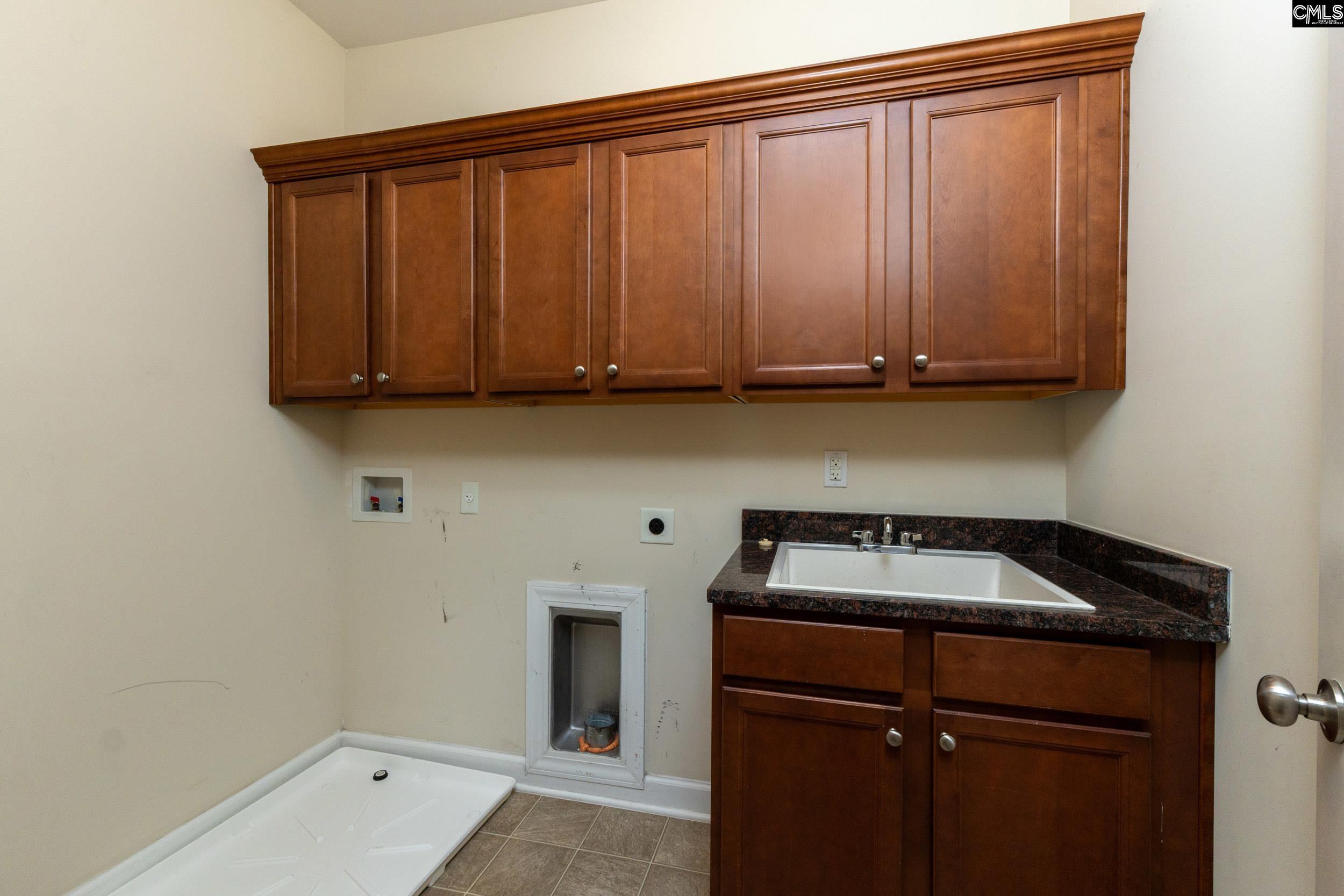 40 Wading Bird Loop Blythewood, SC 29016 - Photo 16 of 26 a kitchen with a sink and cabinets