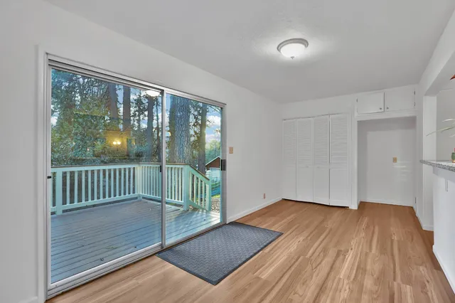 a view of a room with wooden floor and balcony