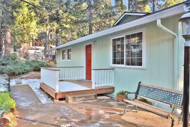 a view of a chair and table in backyard of the house