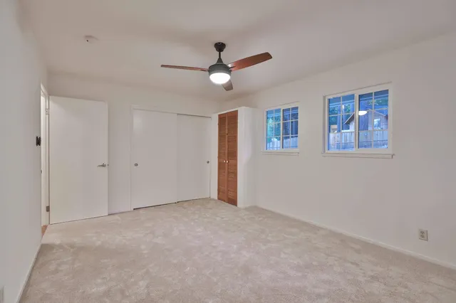 a view of an empty room with a ceiling fan