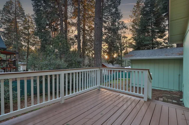 a view of balcony with wooden floor and fence