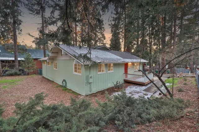 a house that has a tree in front of it