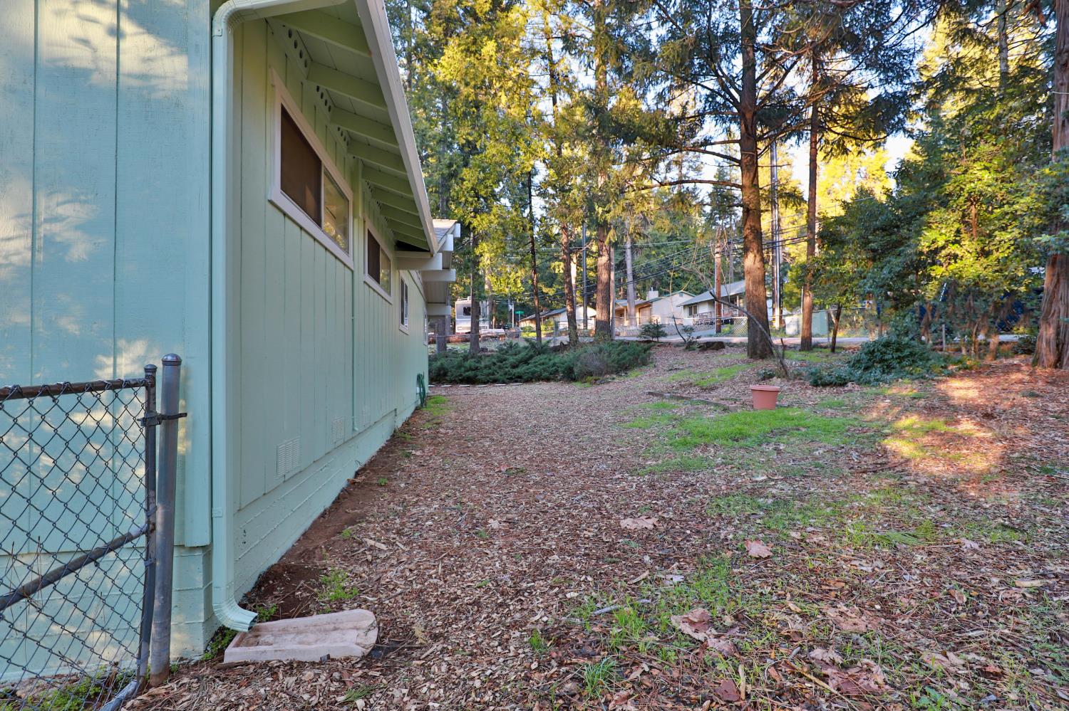 3060 Leaf Circle Pollock Pines, CA 95726 - Photo 36 of 38 a backyard of a house with lots of green space