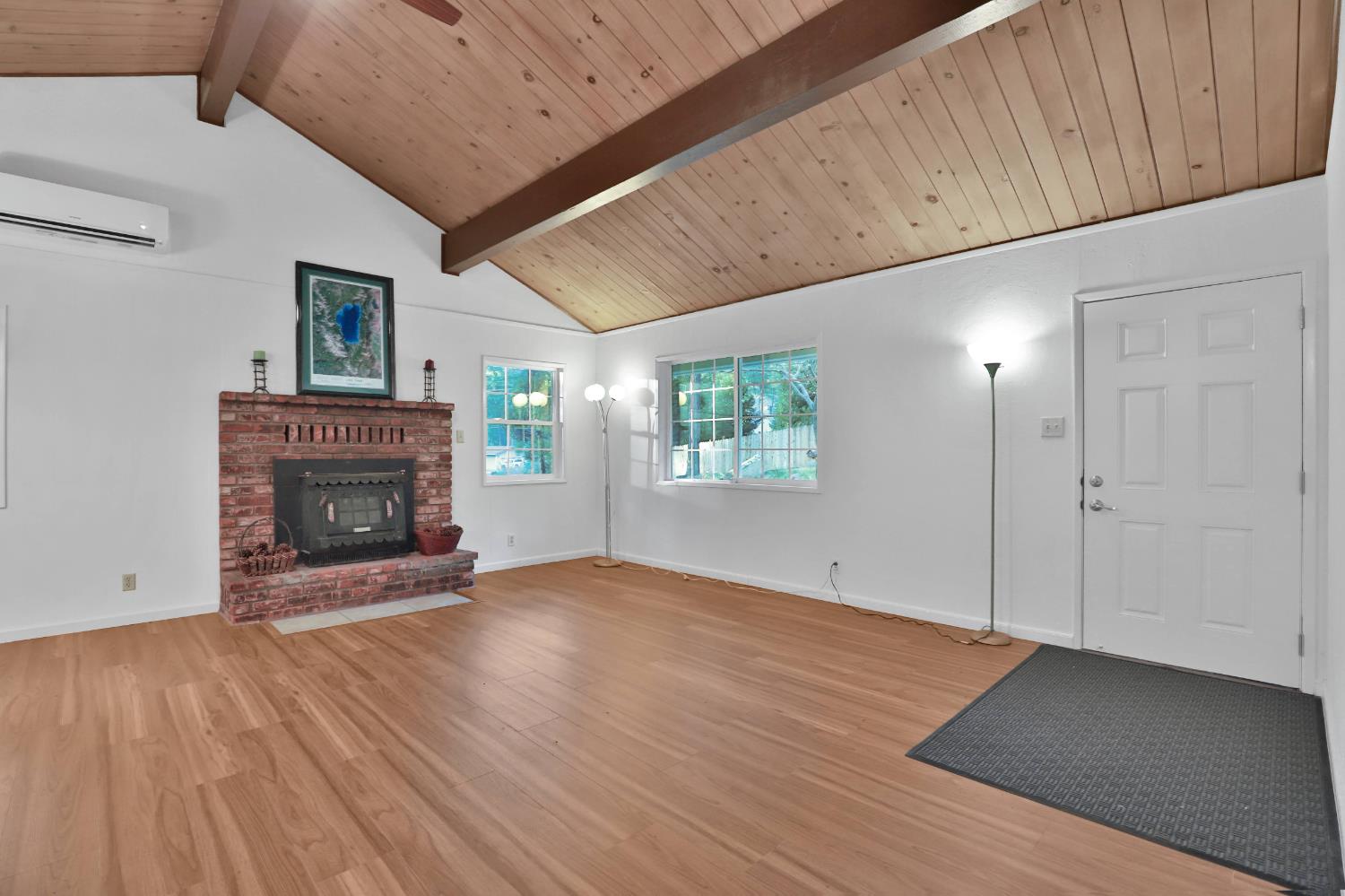 3060 Leaf Circle Pollock Pines, CA 95726 - Photo 5 of 38 a view of an empty room with wooden floor fireplace and a window