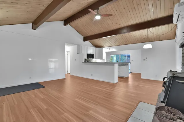 a view of kitchen and hall with wooden floor