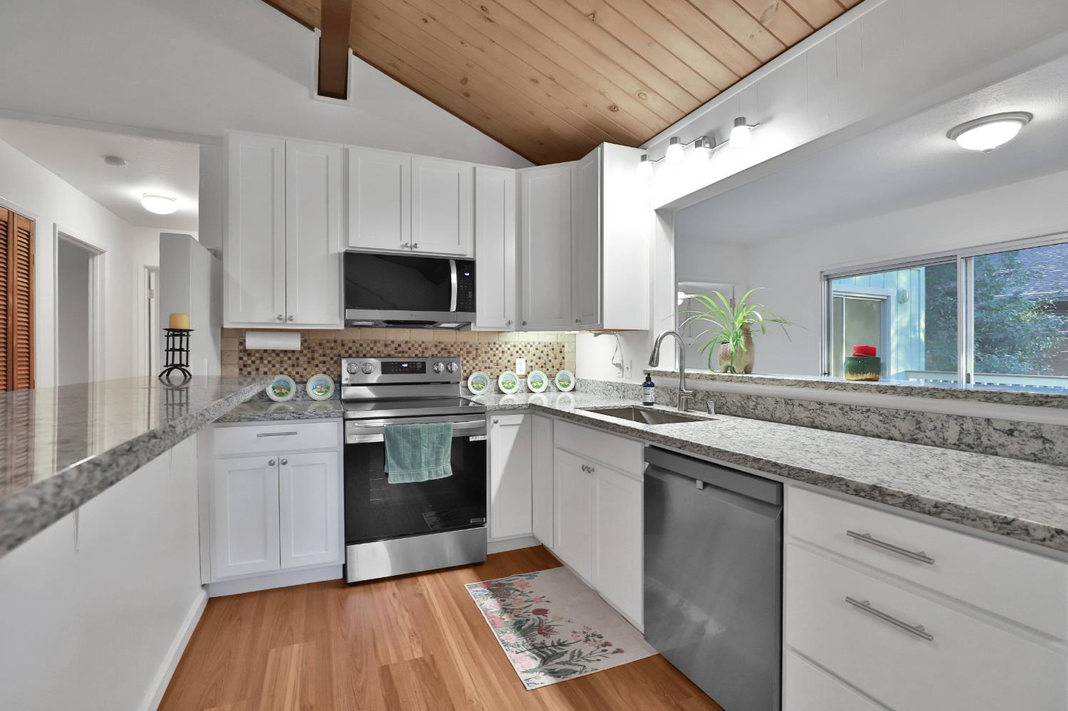 3060 Leaf Circle Pollock Pines, CA 95726 - Photo 9 of 38 a kitchen with stainless steel appliances granite countertop a stove and a sink