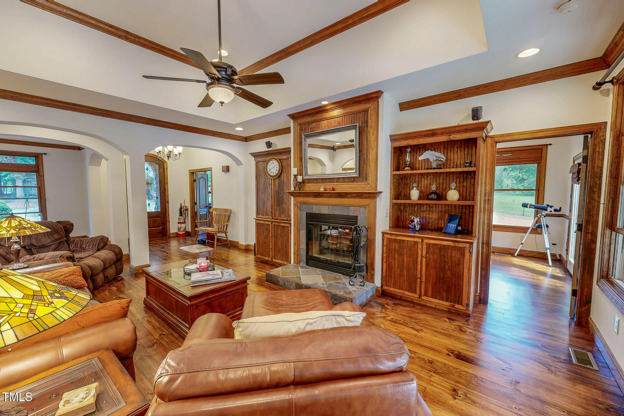 576 Duncan Road Timberlake, NC 27583 - Photo 36 of 91 a living room with furniture a fireplace and a ceiling fan