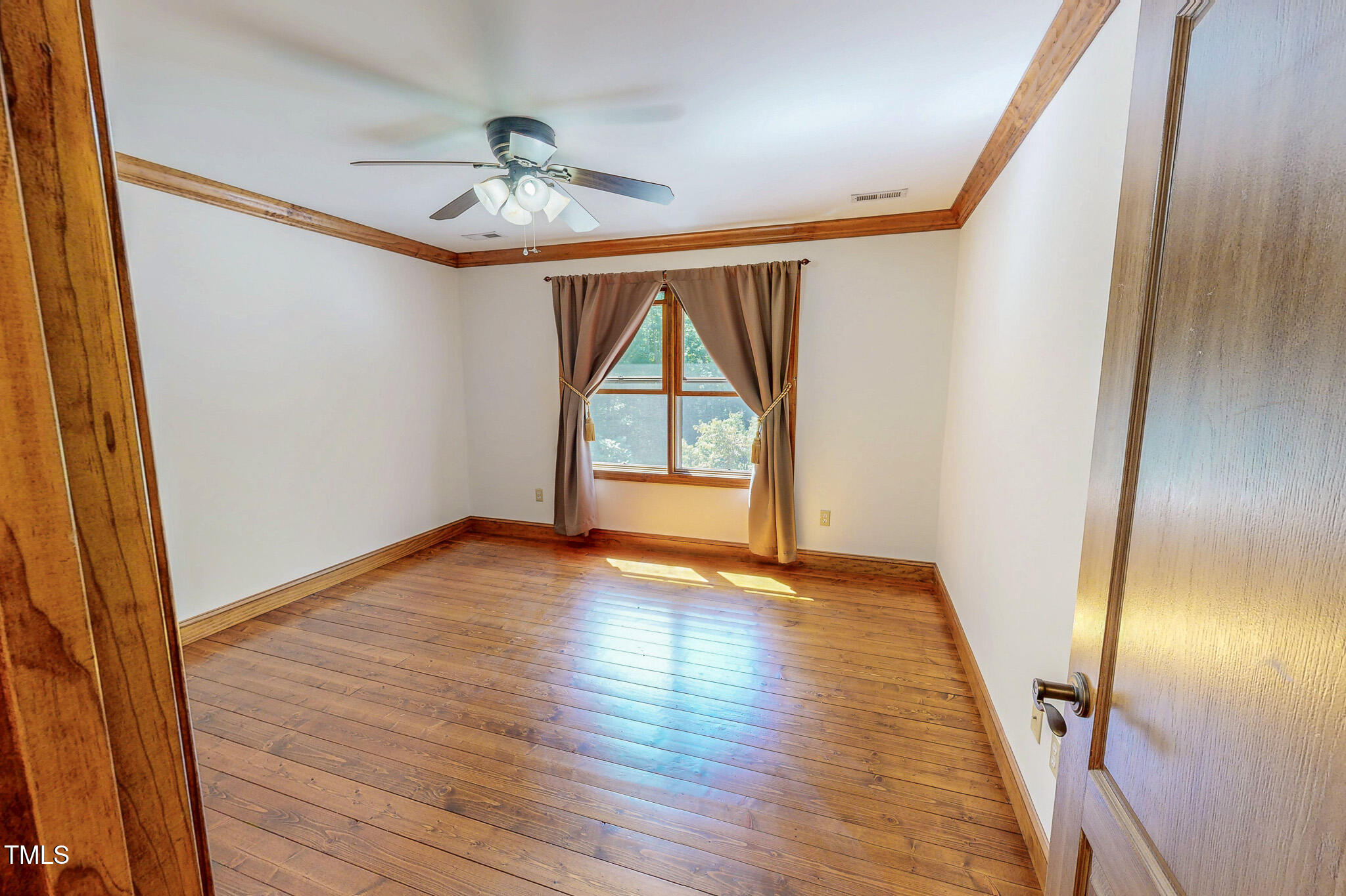 576 Duncan Road Timberlake, NC 27583 - Photo 64 of 91 a view of an empty room with wooden floor and fan