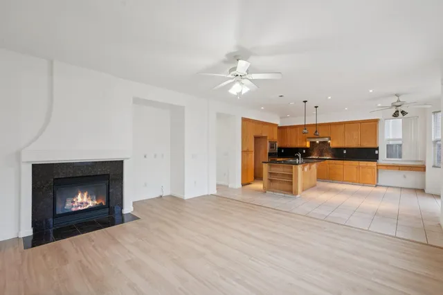 a kitchen with stainless steel appliances a refrigerator sink and microwave
