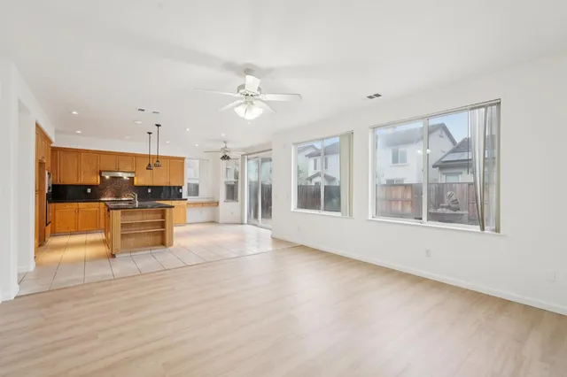 a kitchen with stainless steel appliances granite countertop a sink a counter top space and cabinets