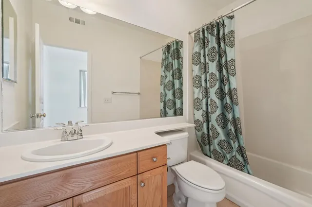 a spacious bathroom with a tub sink and mirror