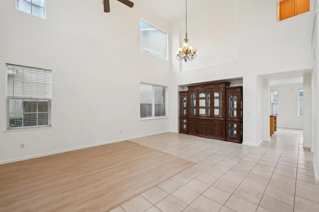 a dining room with furniture a chandelier and window
