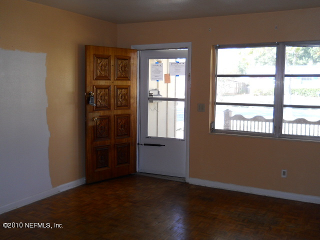 4005 Dayrl Road Jacksonville, FL 32207 - Photo 3 of 14 an empty room with wooden floor and windows
