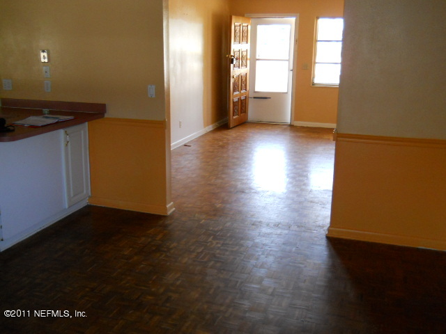 4005 Dayrl Road Jacksonville, FL 32207 - Photo 5 of 14 an empty room with wooden floor and windows