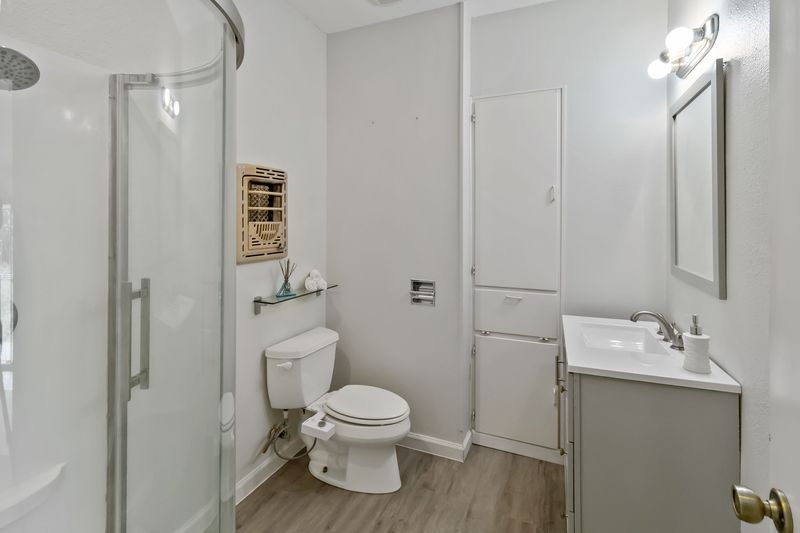 605 West 11th Street Elgin, TX 78621 - Photo 22 of 31 Full bath featuring a stall shower, vanity, and light wood finished floors