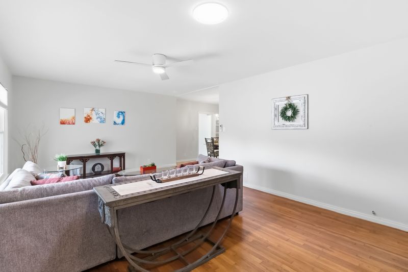 605 West 11th Street Elgin, TX 78621 - Photo 4 of 31 Living area featuring ceiling fan and wood finished floors